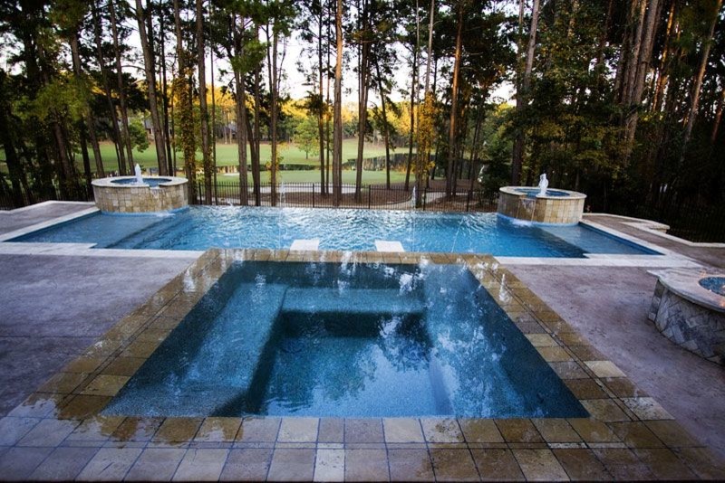 Large backyard brick and custom-shaped natural pool photo in Austin