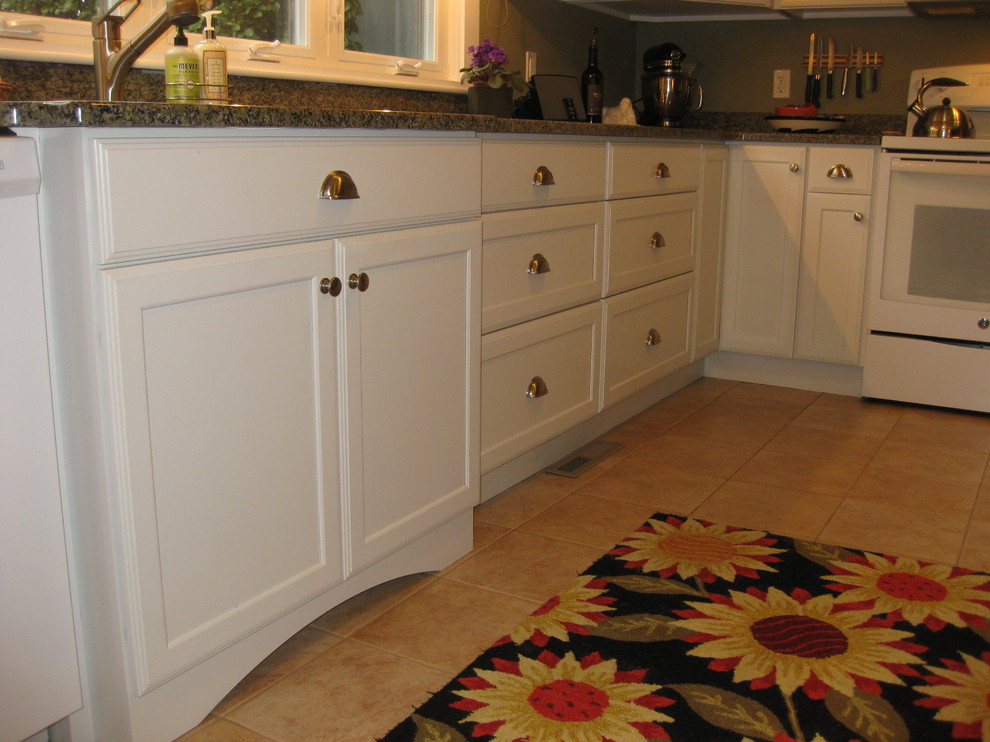 Kitchen - transitional l-shaped ceramic tile and beige floor kitchen idea in Boston with an undermount sink, shaker cabinets, white cabinets, granite countertops, white appliances and green countertops