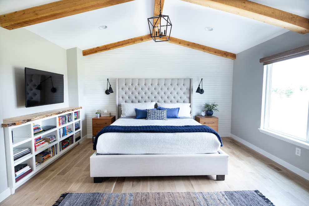 This is an example of a transitional master bedroom in Denver with light hardwood floors, grey walls and multi-coloured floor.