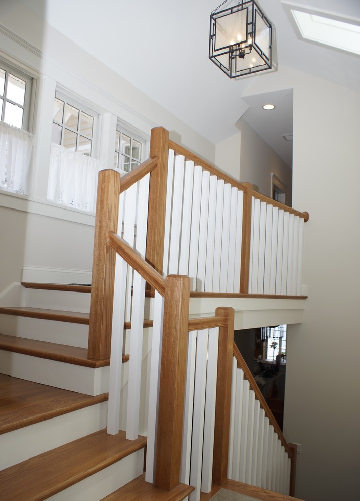 Example of a mid-sized transitional wooden l-shaped staircase design with wooden risers