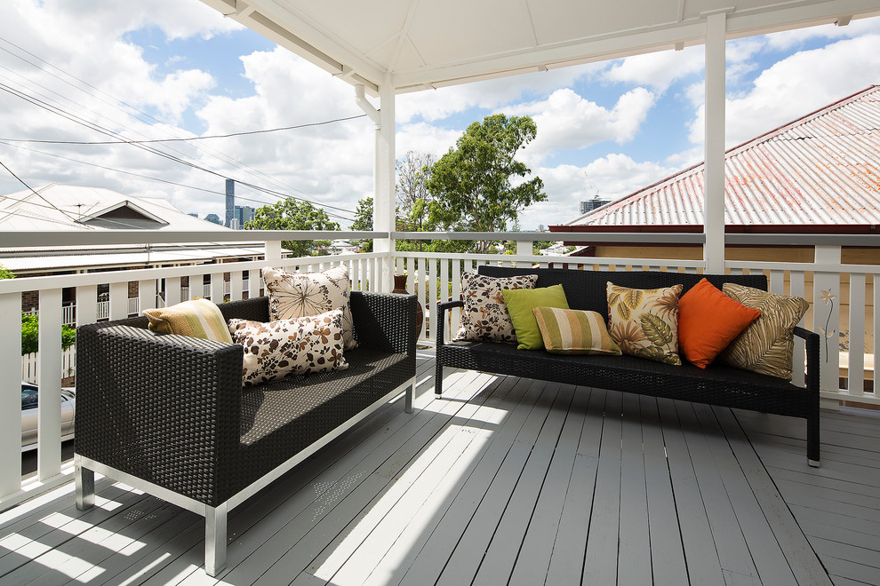 Design ideas for a small transitional front yard verandah in Gold Coast - Tweed with decking and a roof extension.