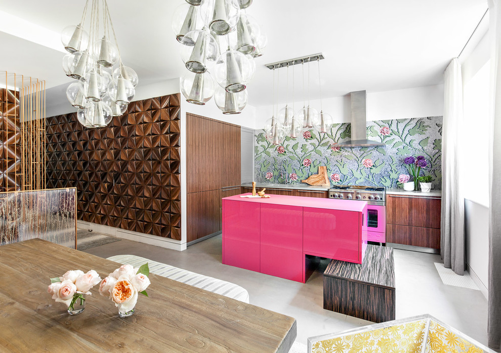 Large contemporary l-shaped eat-in kitchen in New York with a double-bowl sink, flat-panel cabinets, medium wood cabinets, concrete benchtops, multi-coloured splashback, glass tile splashback, coloured appliances, concrete floors and with island.