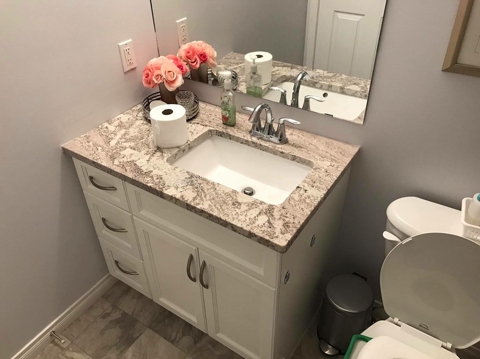 Bathroom - small transitional 3/4 black tile and ceramic tile ceramic tile and black floor bathroom idea in Edmonton with shaker cabinets, white cabinets, blue walls, a drop-in sink and granite countertops