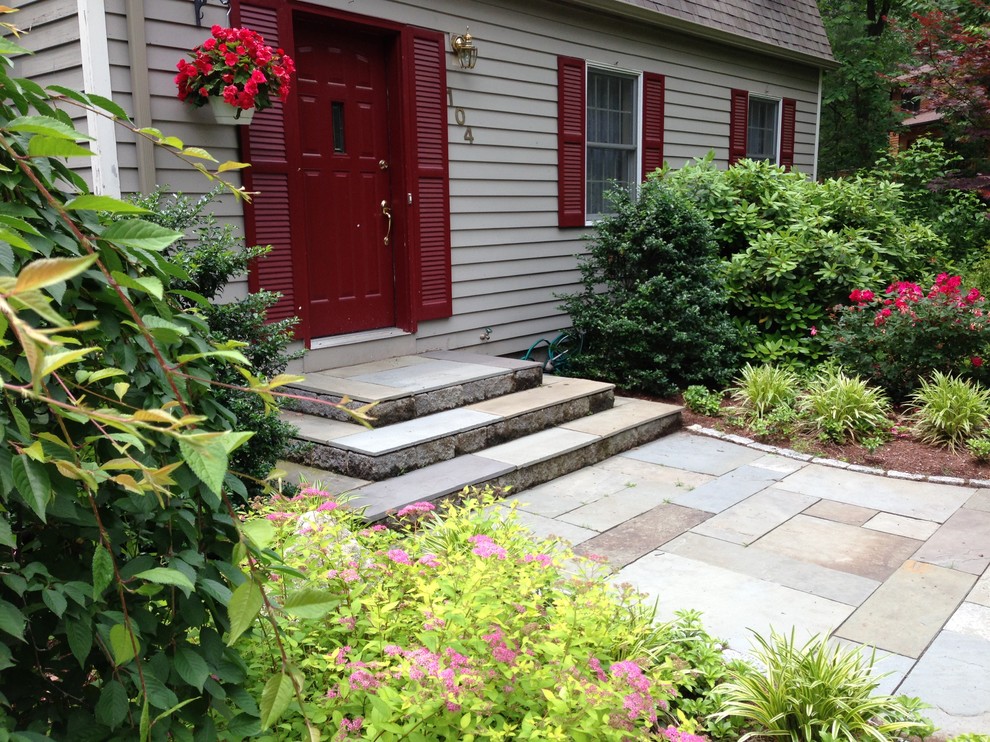 Inspiration for a mid-sized transitional front yard partial sun garden in Boston with a garden path and natural stone pavers.