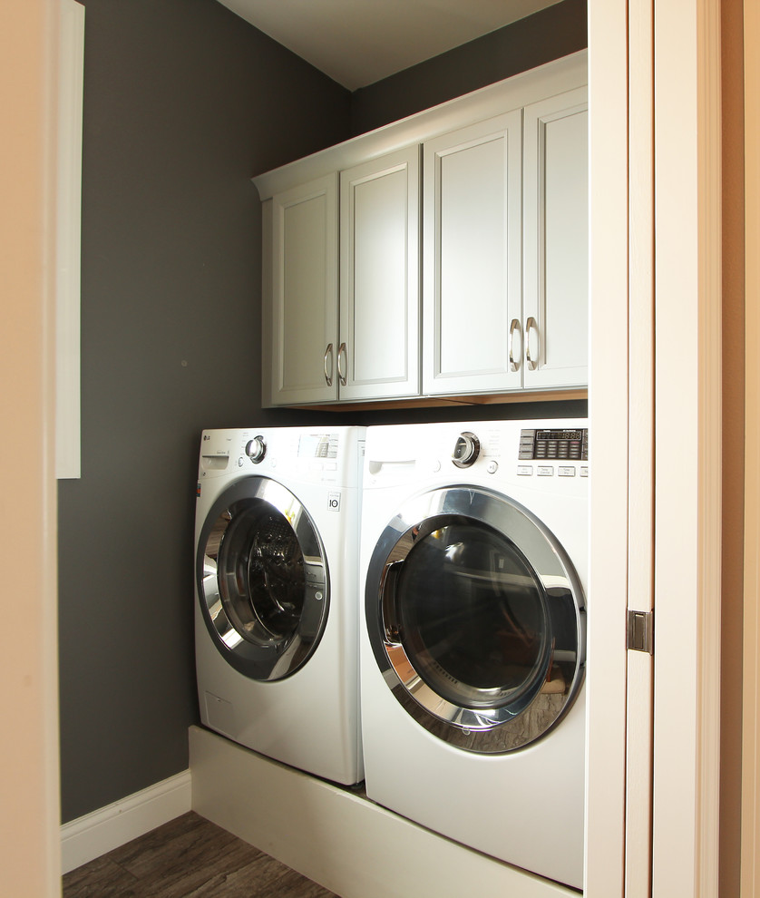 Small transitional galley dedicated laundry room in Other with recessed-panel cabinets, beige cabinets, quartz benchtops, grey walls, porcelain floors, a side-by-side washer and dryer, brown floor and white benchtop.