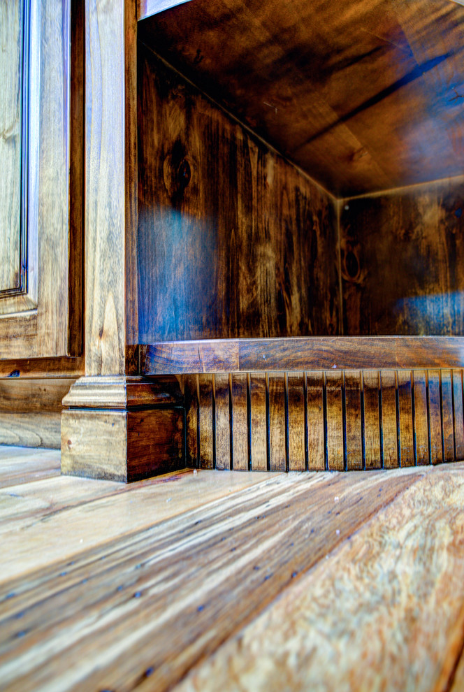 Inspiration for a large rustic u-shaped medium tone wood floor kitchen pantry remodel with a drop-in sink, glass-front cabinets, medium tone wood cabinets, beige backsplash, stainless steel appliances and an island