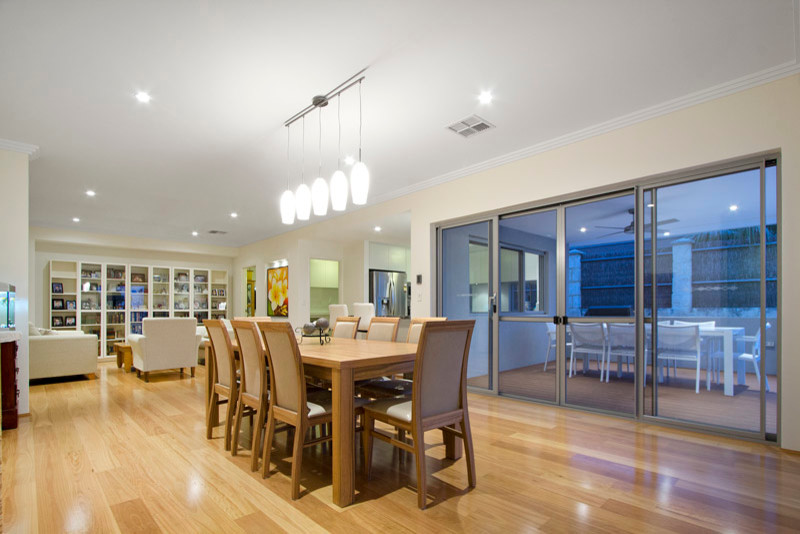 Transitional open plan dining in Perth with beige walls and light hardwood floors.
