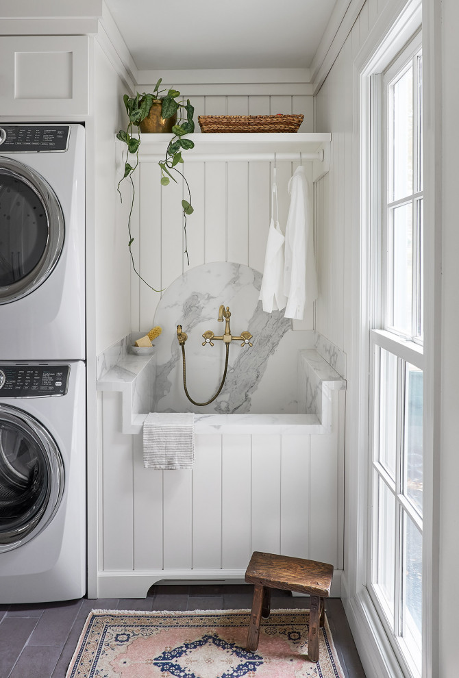 Inspiration for a large beach style galley utility room in Chicago with an undermount sink, shaker cabinets, white cabinets, white walls, brick floors, a stacked washer and dryer, grey benchtop and planked wall panelling.