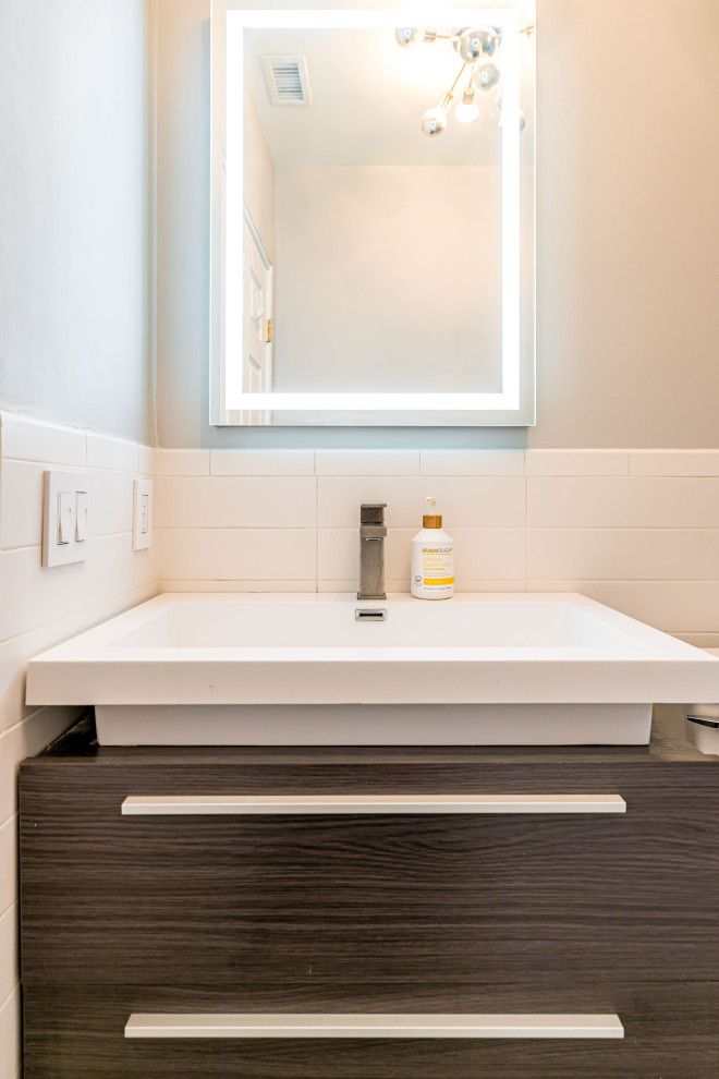 Photo of a modern bathroom in Los Angeles with glass-front cabinets, white walls, a drop-in sink, a hinged shower door, brown benchtops, a floating vanity, wood, wood walls, brown cabinets, beige floor and a single vanity.