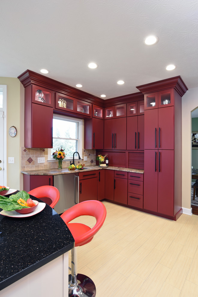Enclosed kitchen - large transitional porcelain tile and beige floor enclosed kitchen idea with an undermount sink, flat-panel cabinets, red cabinets, granite countertops, beige backsplash, travertine backsplash, stainless steel appliances and an island