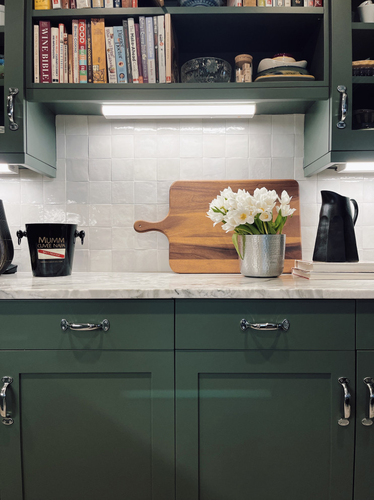 Mid-sized transitional l-shaped marble floor and beige floor enclosed kitchen photo with an undermount sink, shaker cabinets, green cabinets, quartzite countertops, white backsplash, ceramic backsplash, stainless steel appliances, a peninsula and gray countertops