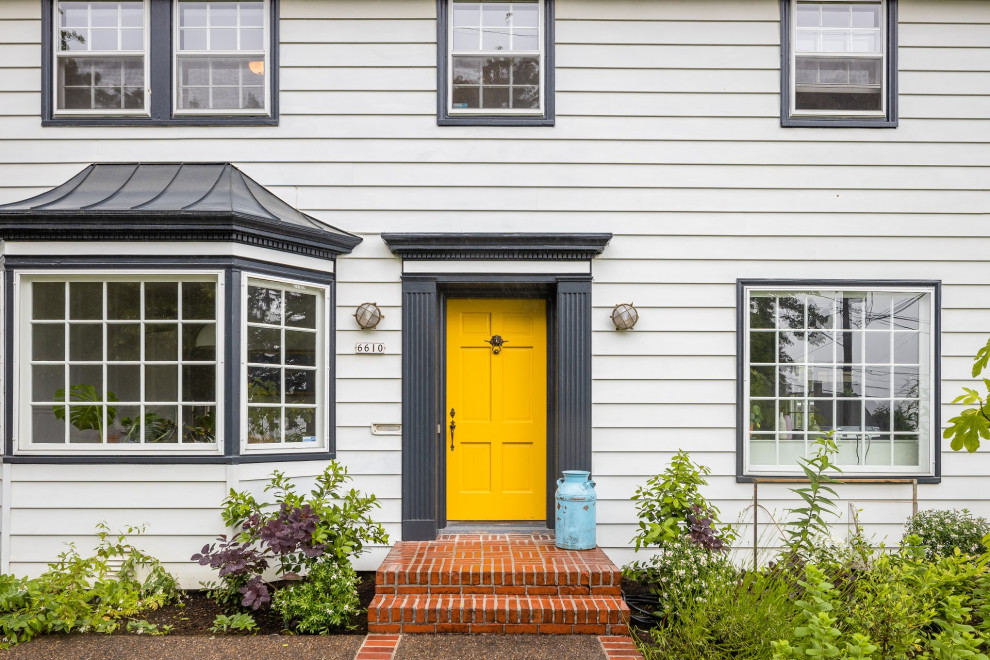Design ideas for a traditional front door in Portland with a single front door and a yellow front door.