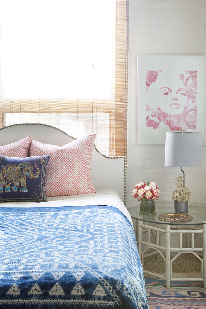 This is an example of an eclectic bedroom in Philadelphia with white walls and carpet.