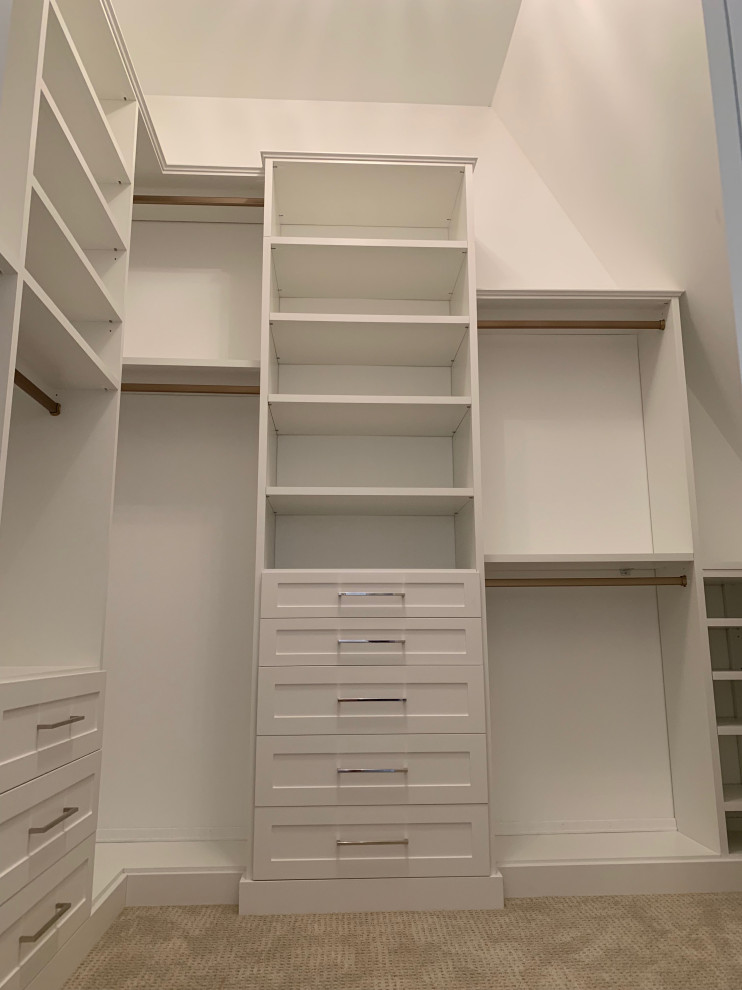 This is an example of a mid-sized traditional walk-in wardrobe in Chicago with shaker cabinets, white cabinets, carpet and grey floor.