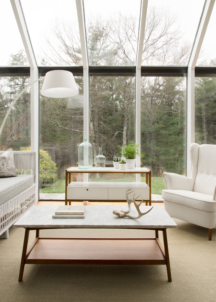 Small modern sunroom in Boston with light hardwood floors, no fireplace and a glass ceiling.