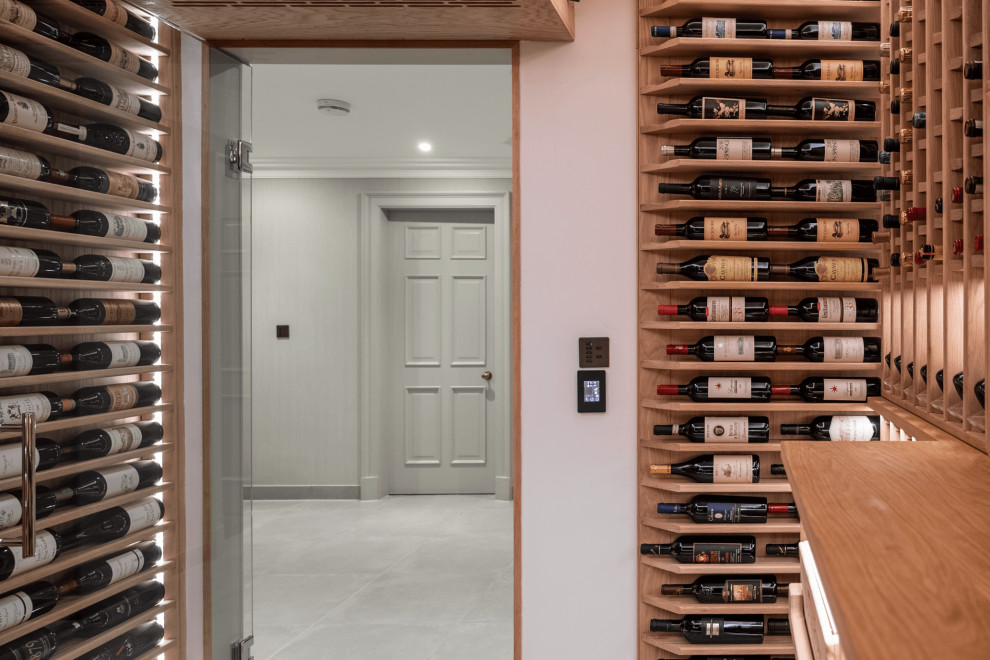Inspiration for a medium sized modern wine cellar in Surrey with marble flooring, storage racks and grey floors.
