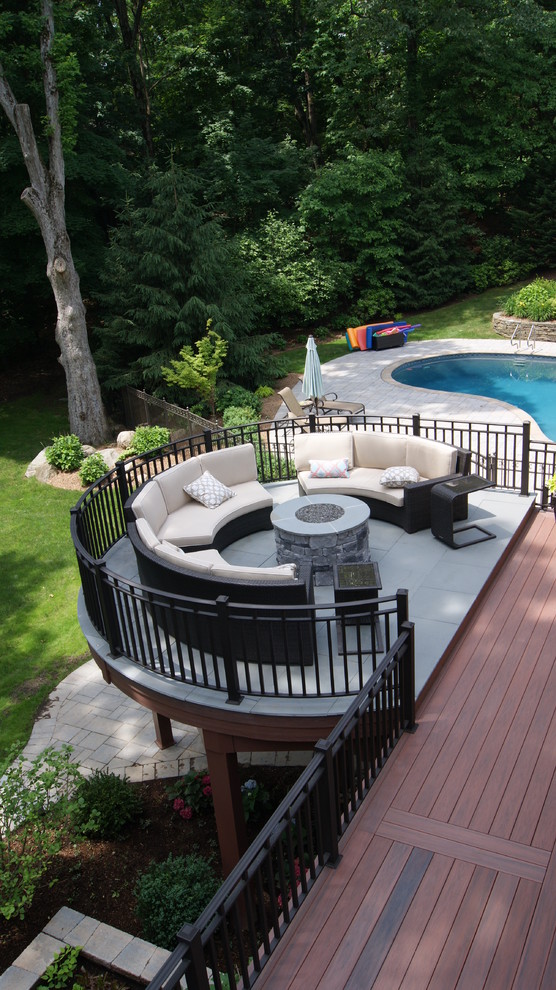 Design ideas for an expansive arts and crafts backyard deck in New York with a fire feature.