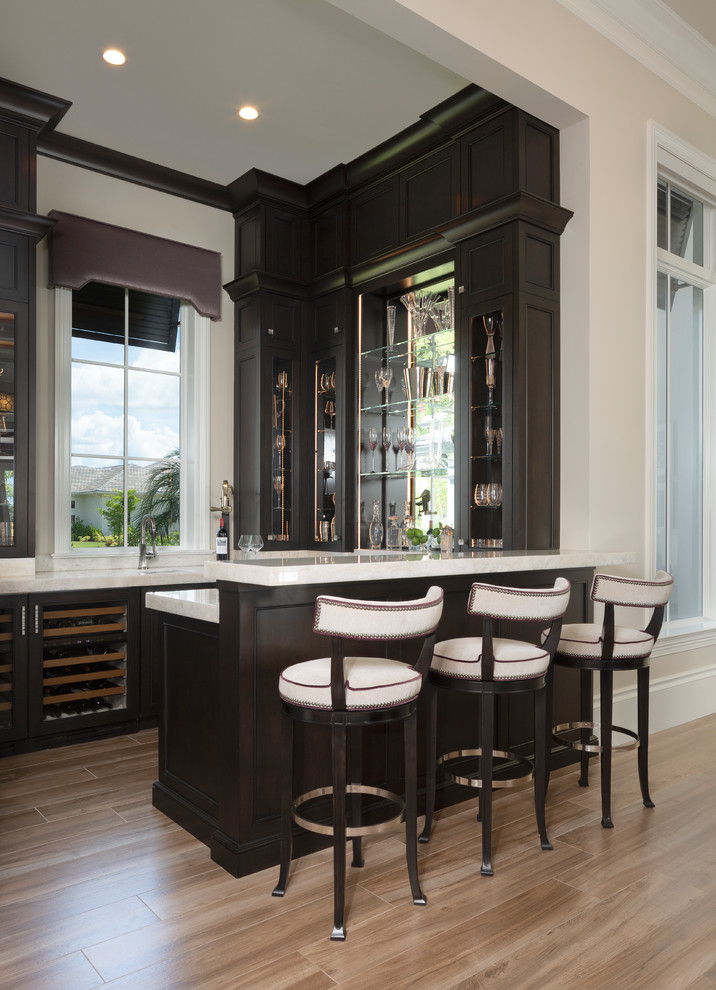 Mid-sized contemporary u-shaped seated home bar in Miami with an undermount sink, glass-front cabinets and dark wood cabinets.