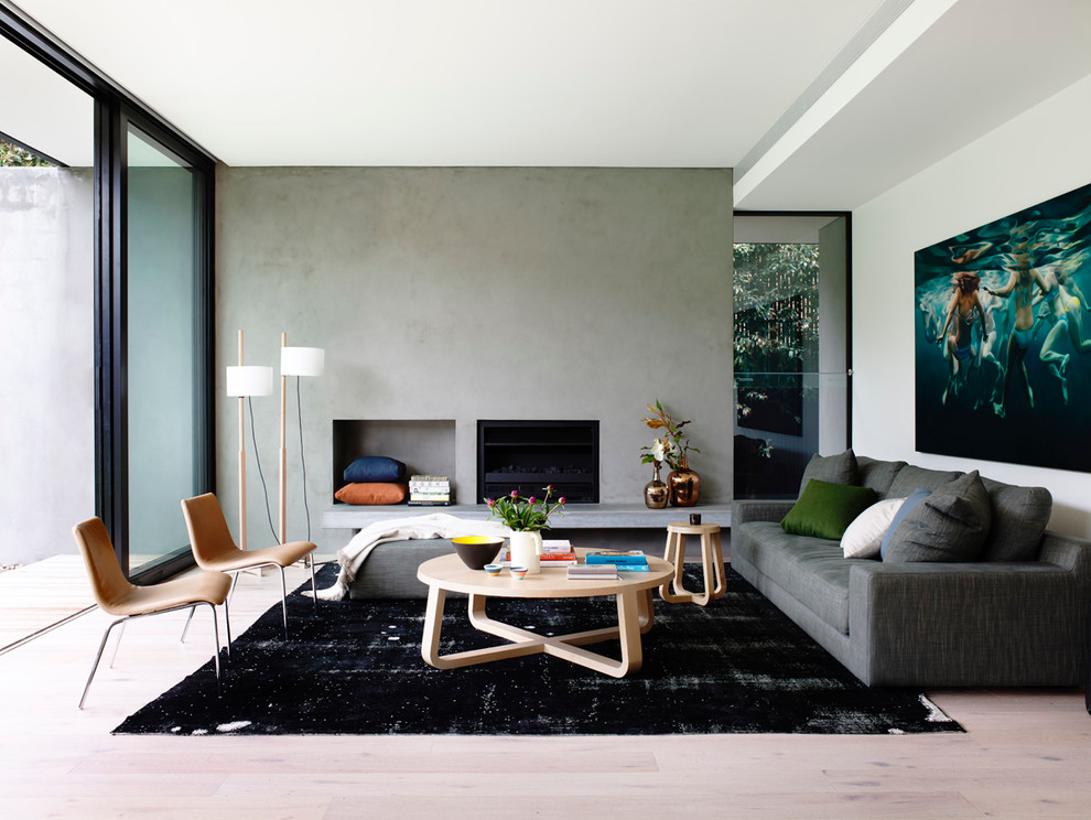 This is an example of a mid-sized modern open concept living room in Melbourne with light hardwood floors, no tv and a ribbon fireplace.