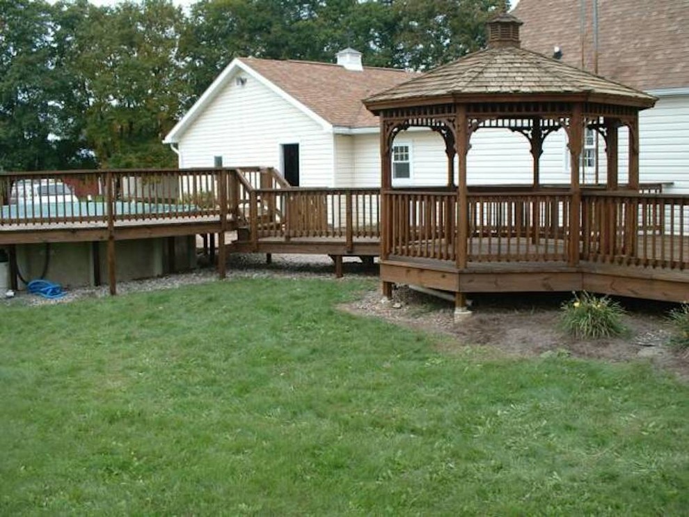 Example of a backyard wood white deck design