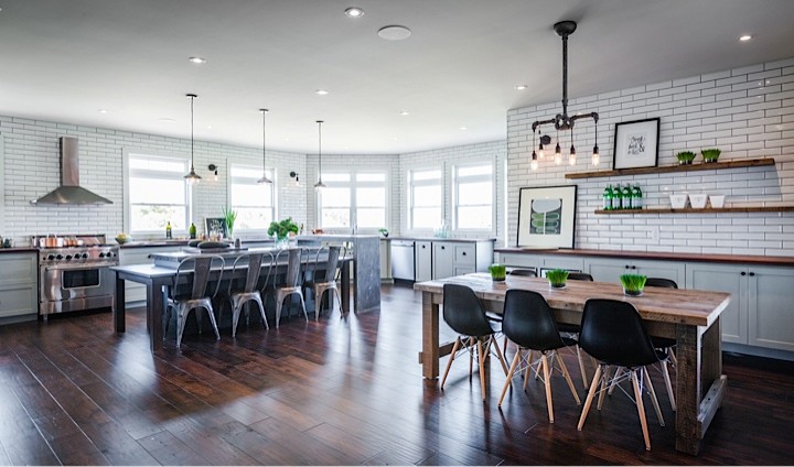 Large mountain style u-shaped medium tone wood floor eat-in kitchen photo with an integrated sink, shaker cabinets, green cabinets, concrete countertops, white backsplash, subway tile backsplash, stainless steel appliances and an island
