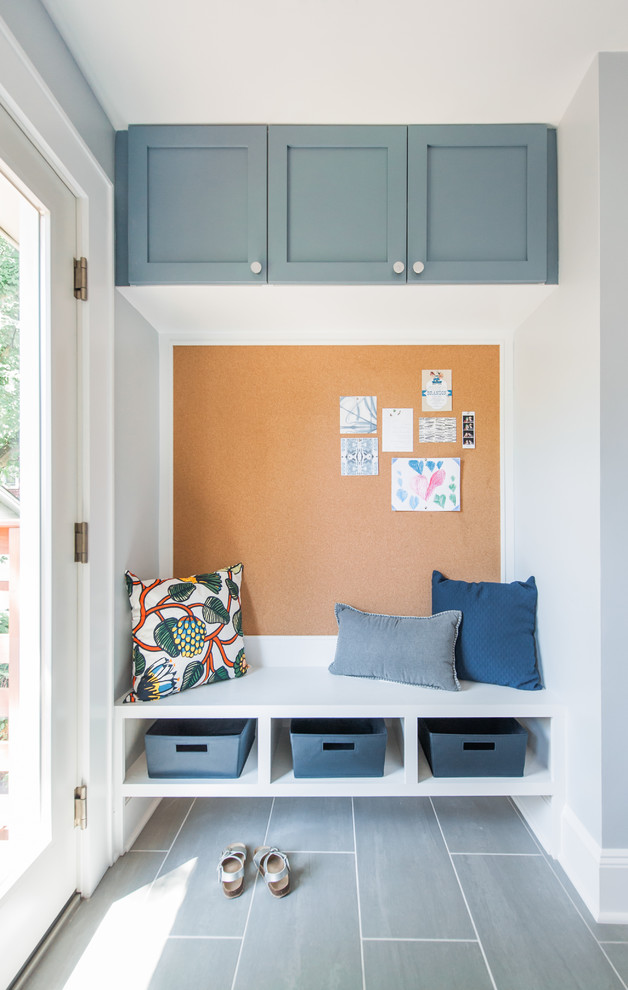 Mid-sized transitional galley porcelain tile and gray floor mudroom photo in New York with an undermount sink, shaker cabinets, blue cabinets, quartz countertops, multicolored backsplash, ceramic backsplash, stainless steel appliances, an island and blue walls