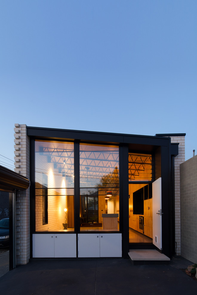 Contemporary one-storey brick white exterior in Melbourne with a flat roof.