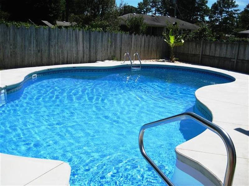 Backyard custom-shaped pool photo