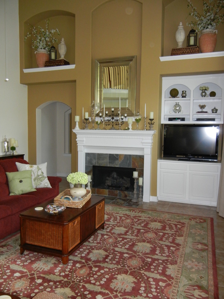 Photo of a traditional living room in Houston with travertine floors, a standard fireplace and a tile fireplace surround.