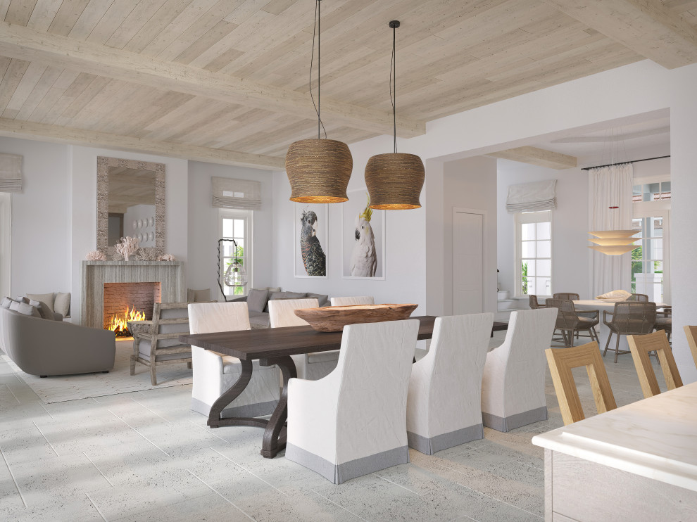 Inspiration for a large beach style family room in Tampa with beige walls, limestone floors, a standard fireplace, a stone fireplace surround, beige floor and exposed beam.