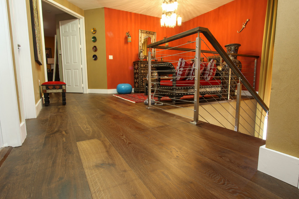 Photo of a mid-sized asian hallway in Miami with dark hardwood floors and red walls.