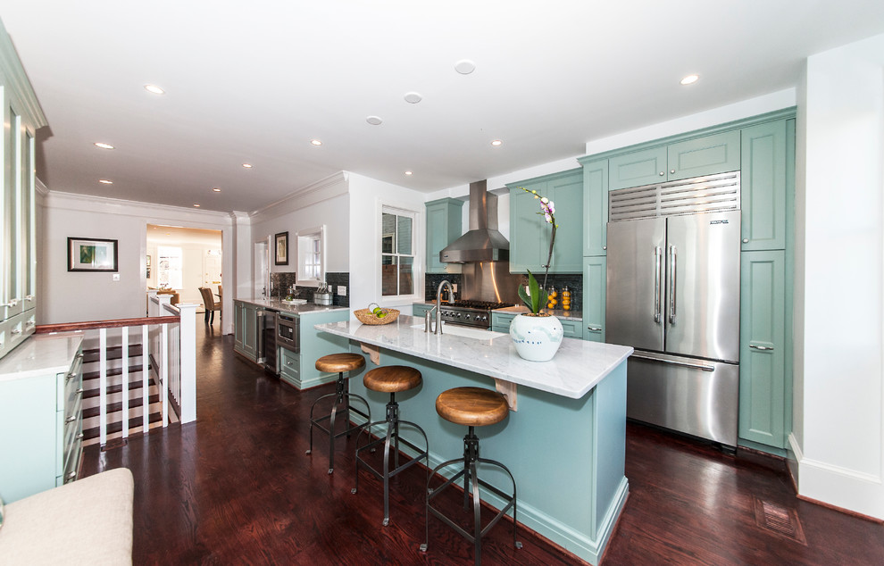 Transitional galley kitchen photo in San Francisco with a farmhouse sink, recessed-panel cabinets, green cabinets, metallic backsplash and stainless steel appliances