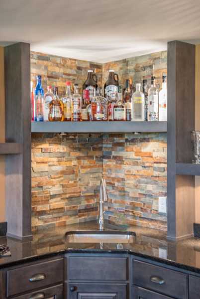 Inspiration for an eclectic u-shaped wet bar in Other with an undermount sink, raised-panel cabinets, grey cabinets, granite benchtops, multi-coloured splashback and stone tile splashback.