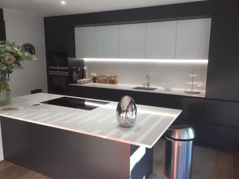 Modern kitchen in Other with quartzite benchtops, white splashback and white benchtop.