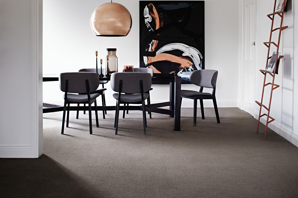 Photo of a mid-sized contemporary separate dining room in Melbourne with white walls and carpet.