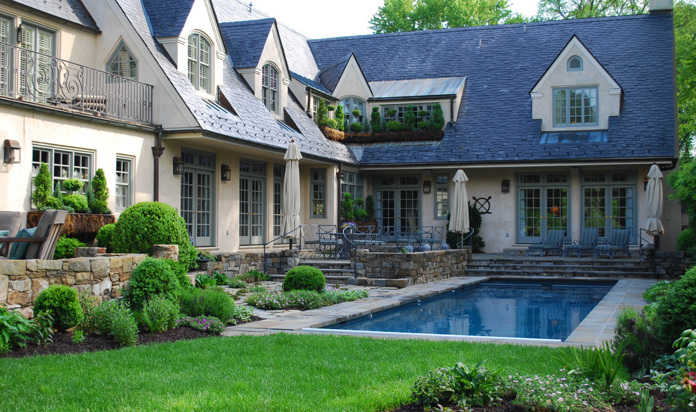 Inspiration for a mid-sized traditional backyard rectangular pool in DC Metro with natural stone pavers.