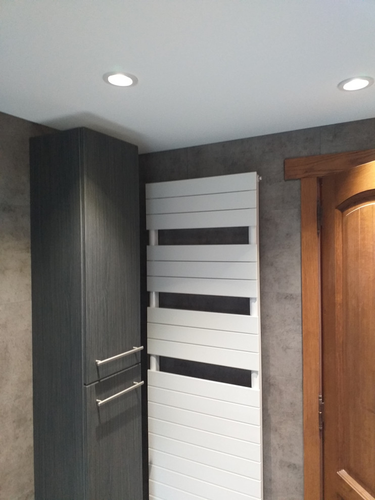 Mid-sized traditional 3/4 bathroom in Lille with flat-panel cabinets, black cabinets, a corner tub, gray tile, ceramic tile, grey walls, painted wood floors, a trough sink, black floor, an open shower and white benchtops.