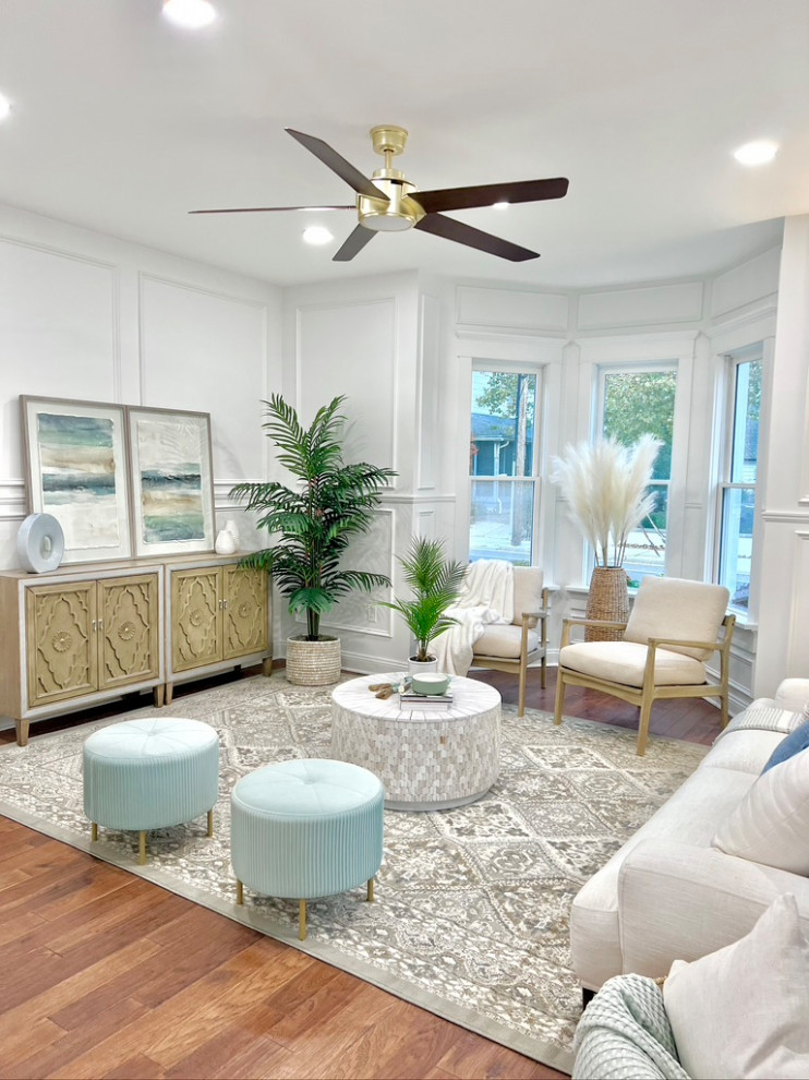 This is an example of a large beach style enclosed living room in Other with white walls, no tv and decorative wall panelling.