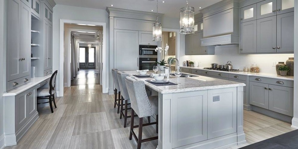Inspiration for a large transitional u-shaped separate kitchen in Miami with an undermount sink, recessed-panel cabinets, grey cabinets, granite benchtops, panelled appliances, porcelain floors, with island and grey floor.