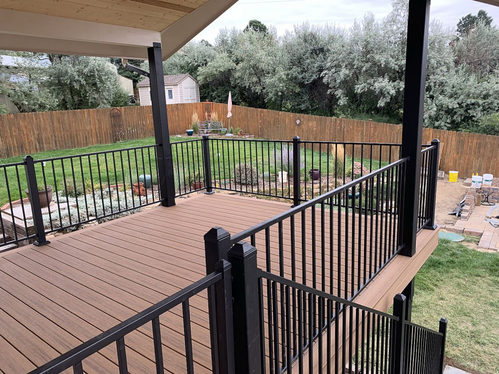 Inspiration for a mid-sized contemporary backyard second story metal railing deck remodel with a roof extension