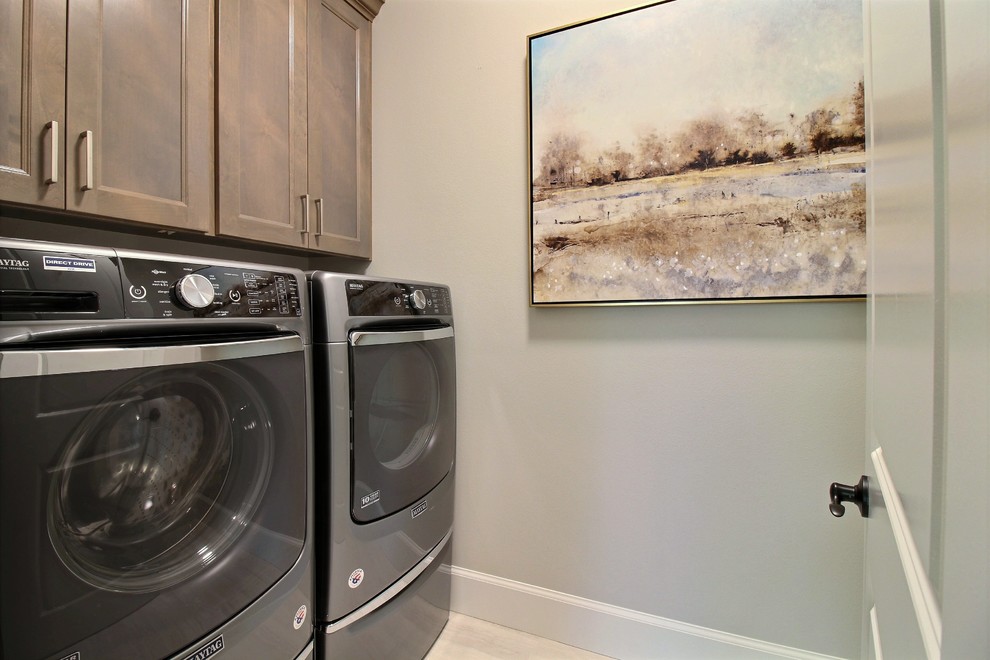 Expansive arts and crafts galley utility room in Portland with a drop-in sink, flat-panel cabinets, brown cabinets, quartz benchtops, grey walls, ceramic floors, a side-by-side washer and dryer, beige floor and white benchtop.