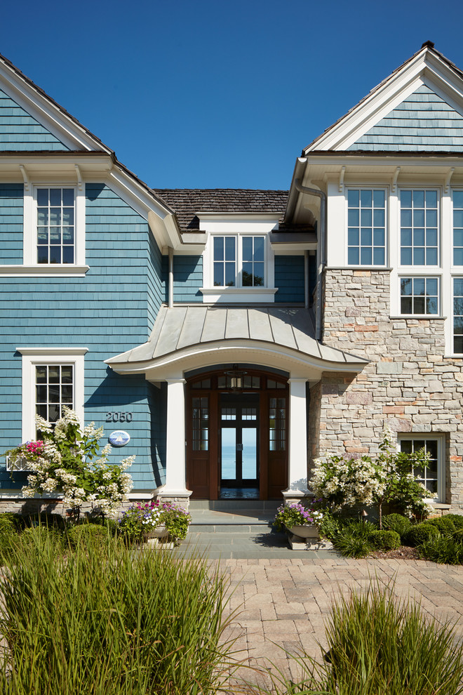 Beach style two-storey blue exterior in Chicago with mixed siding.