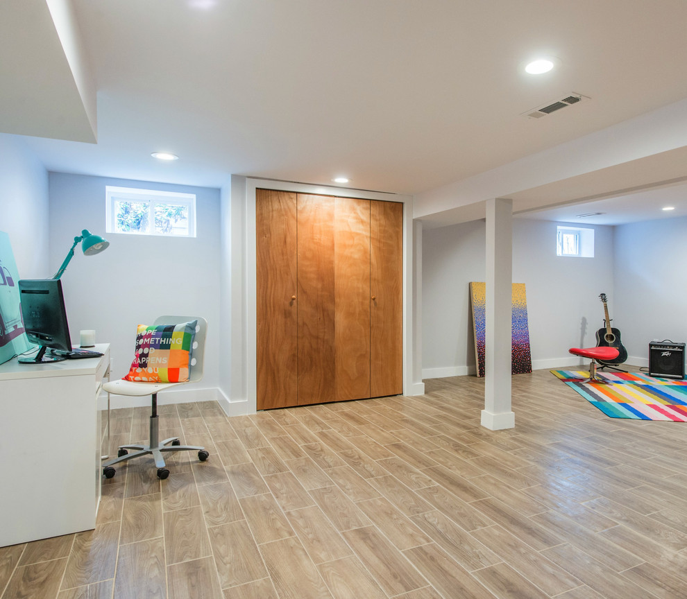 This is an example of a large contemporary look-out basement in New York with white walls, ceramic floors and multi-coloured floor.