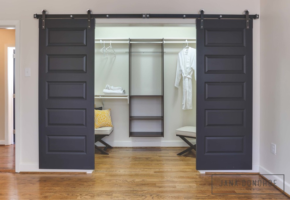 Inspiration for a mid-sized transitional women's walk-in wardrobe in Raleigh with dark hardwood floors.