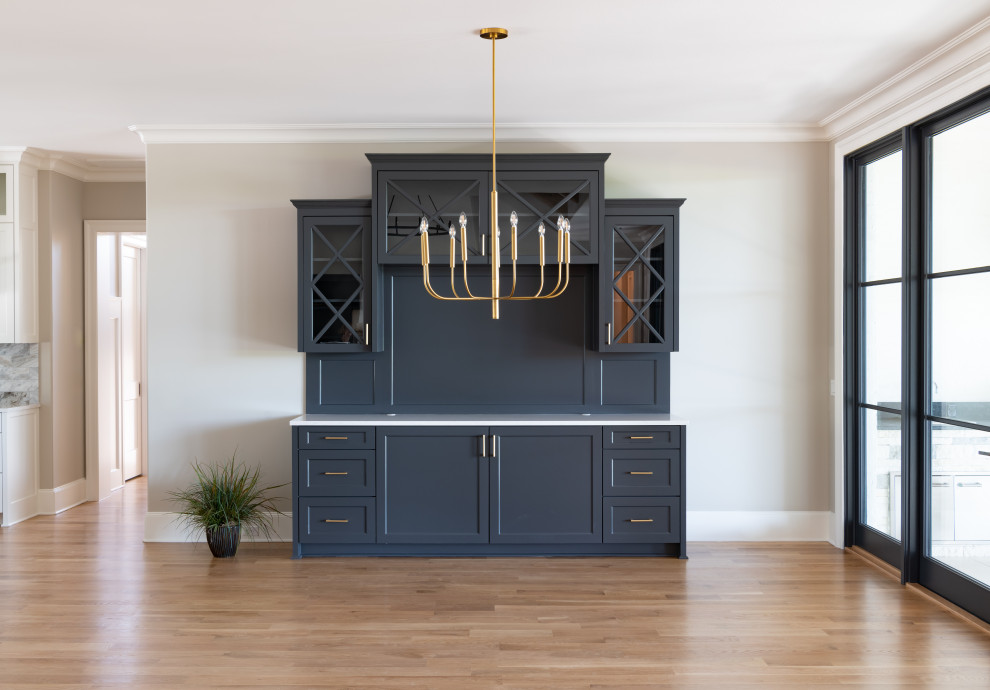 Example of a large transitional medium tone wood floor dining room design in Other with gray walls