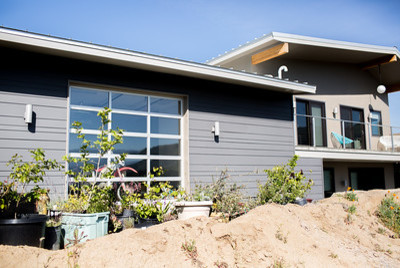 Mid-sized mountain style gray two-story concrete fiberboard exterior home photo with a metal roof
