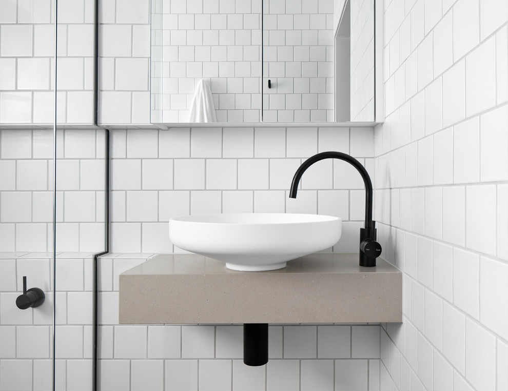 Design ideas for a small scandinavian bathroom in Melbourne with open cabinets, light wood cabinets, a curbless shower, white tile, subway tile, white walls, mosaic tile floors, a wall-mount sink, solid surface benchtops and a hinged shower door.