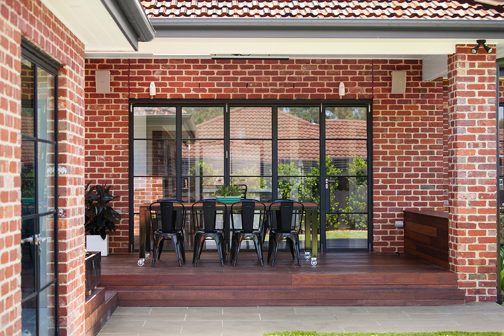 Photo of a traditional deck in Melbourne with a roof extension.
