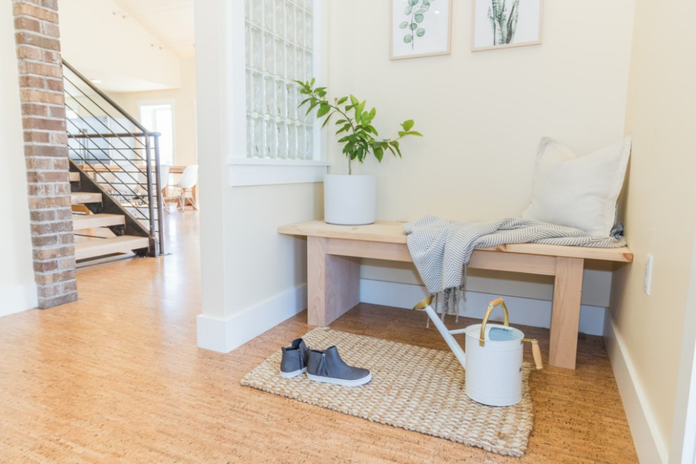 This is an example of a small foyer in Other with yellow walls, cork floors and brown floor.