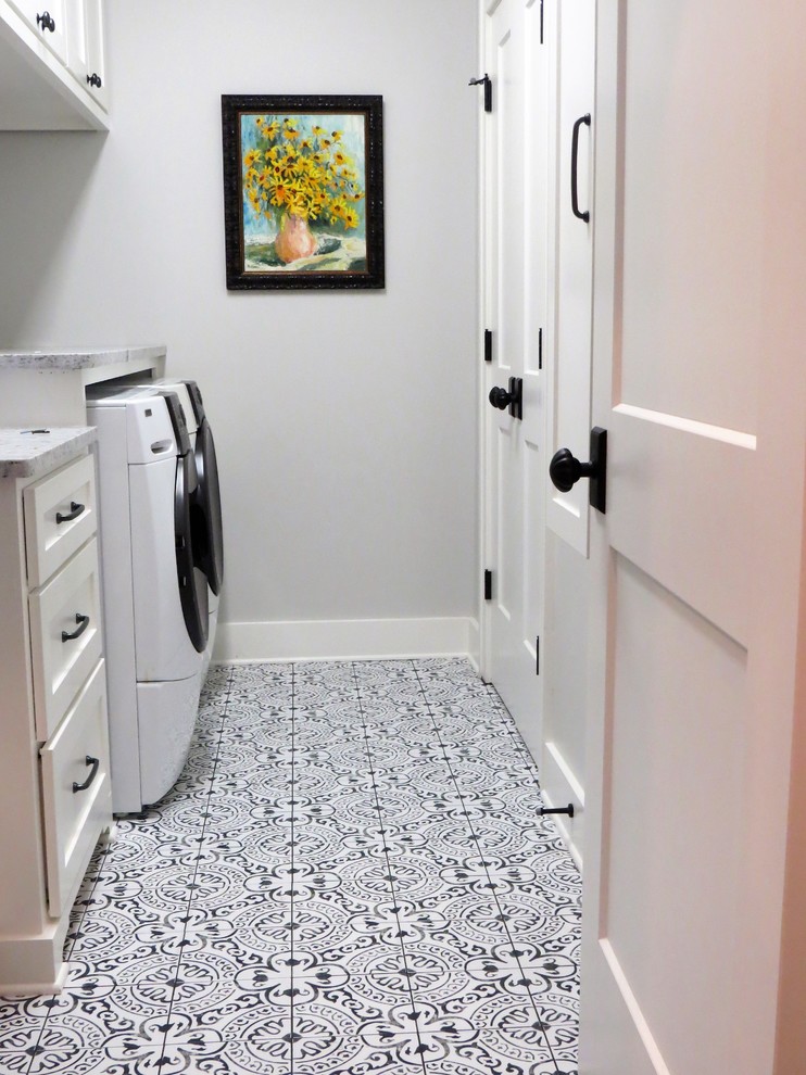 Mid-sized eclectic galley dedicated laundry room in Little Rock with shaker cabinets, white cabinets, granite benchtops, grey walls, porcelain floors, a side-by-side washer and dryer, multi-coloured floor and multi-coloured benchtop.